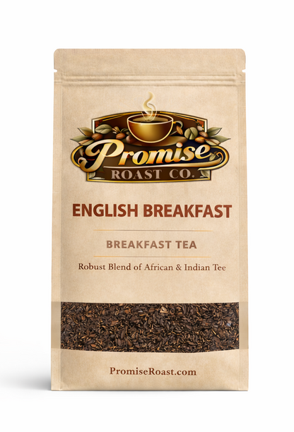 Two packages of Promise Roast Co. English Breakfast tea with a cup of tea and croissant on a wooden table.